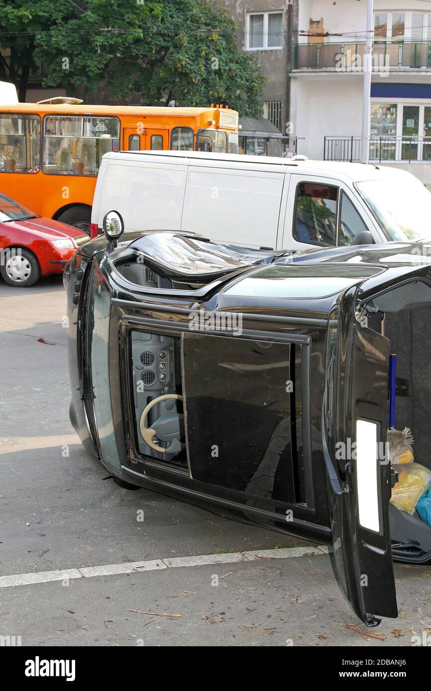 Traffic accident black car roll over side Stock Photo