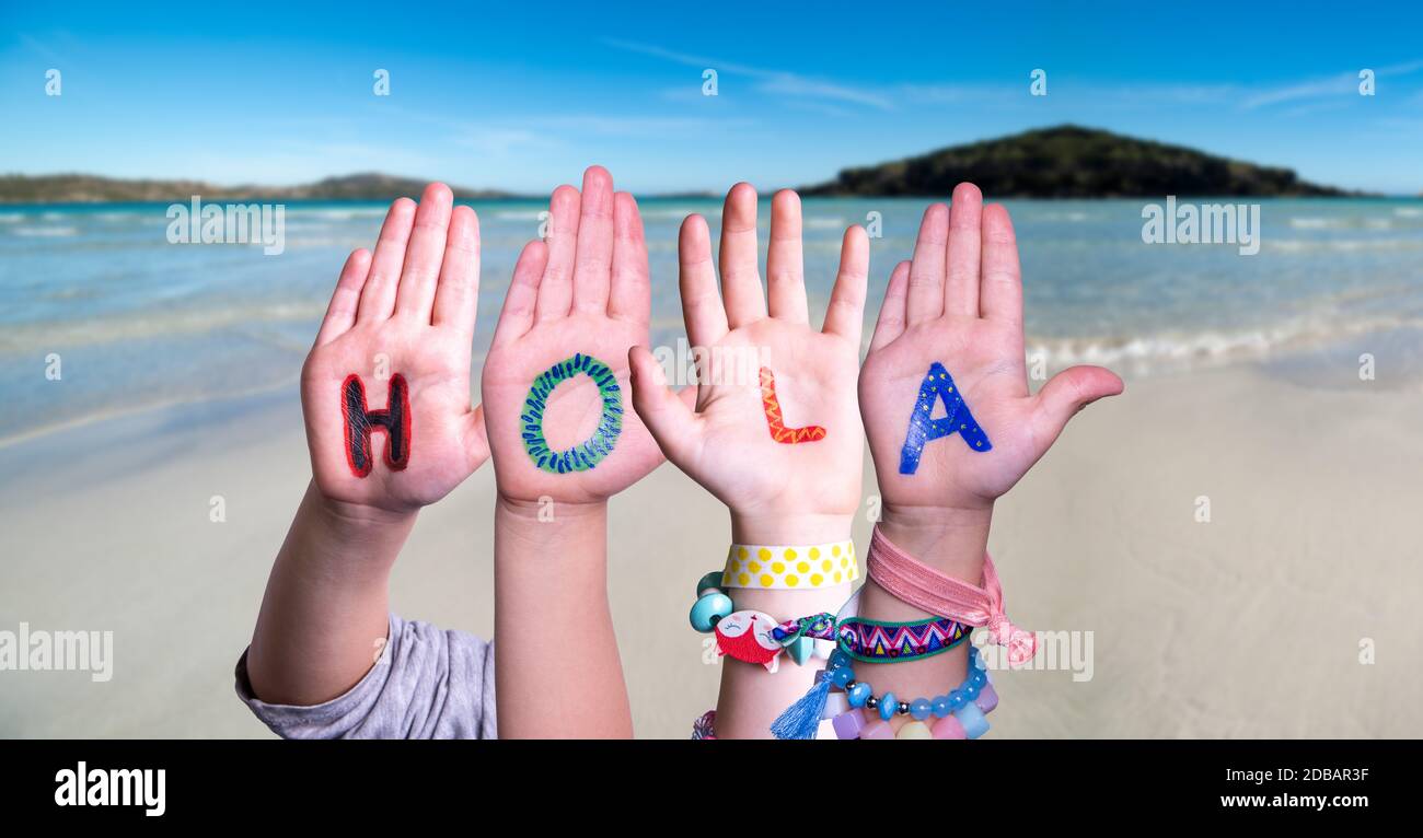 Kids Hands Holding Colorful Spanish Word Hola Means Hello. Ocean And