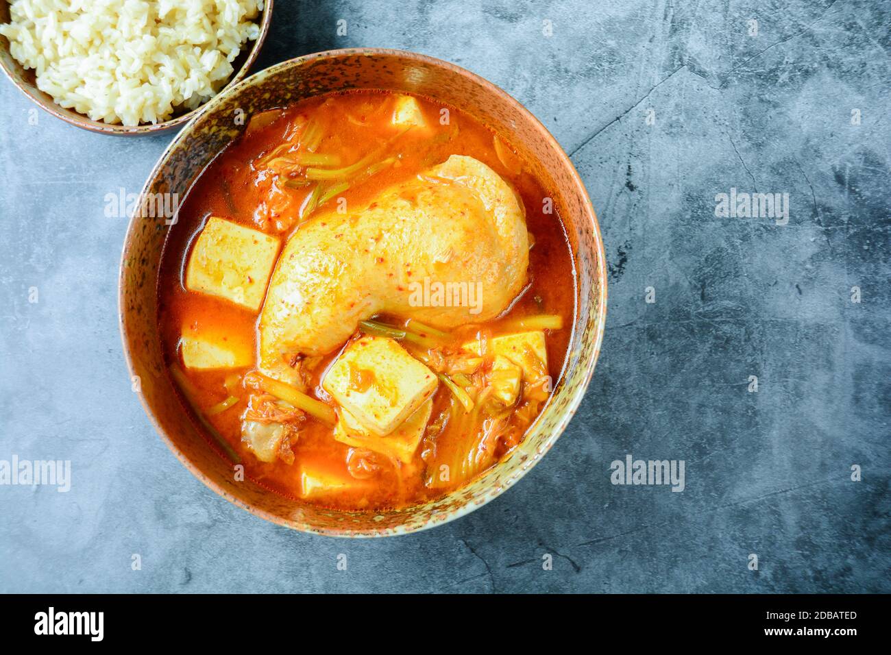 Korean traditional Kimchi soup with chicken and soft tofu Stock Photo