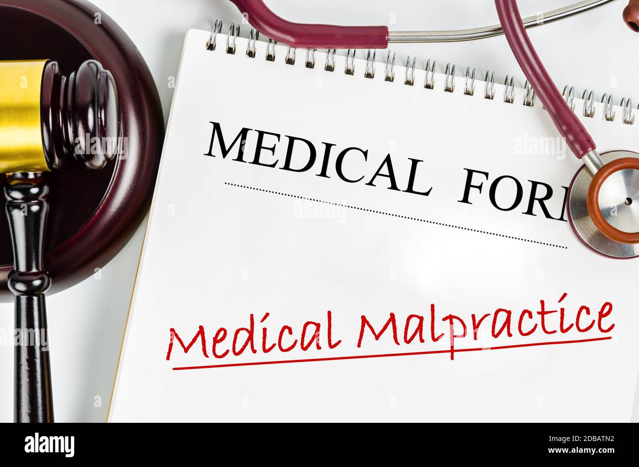 Medical form with words Medical Malpractice and judge's hammer gavel and stethoscope medical. Medical malpractice law concept. Stock Photo