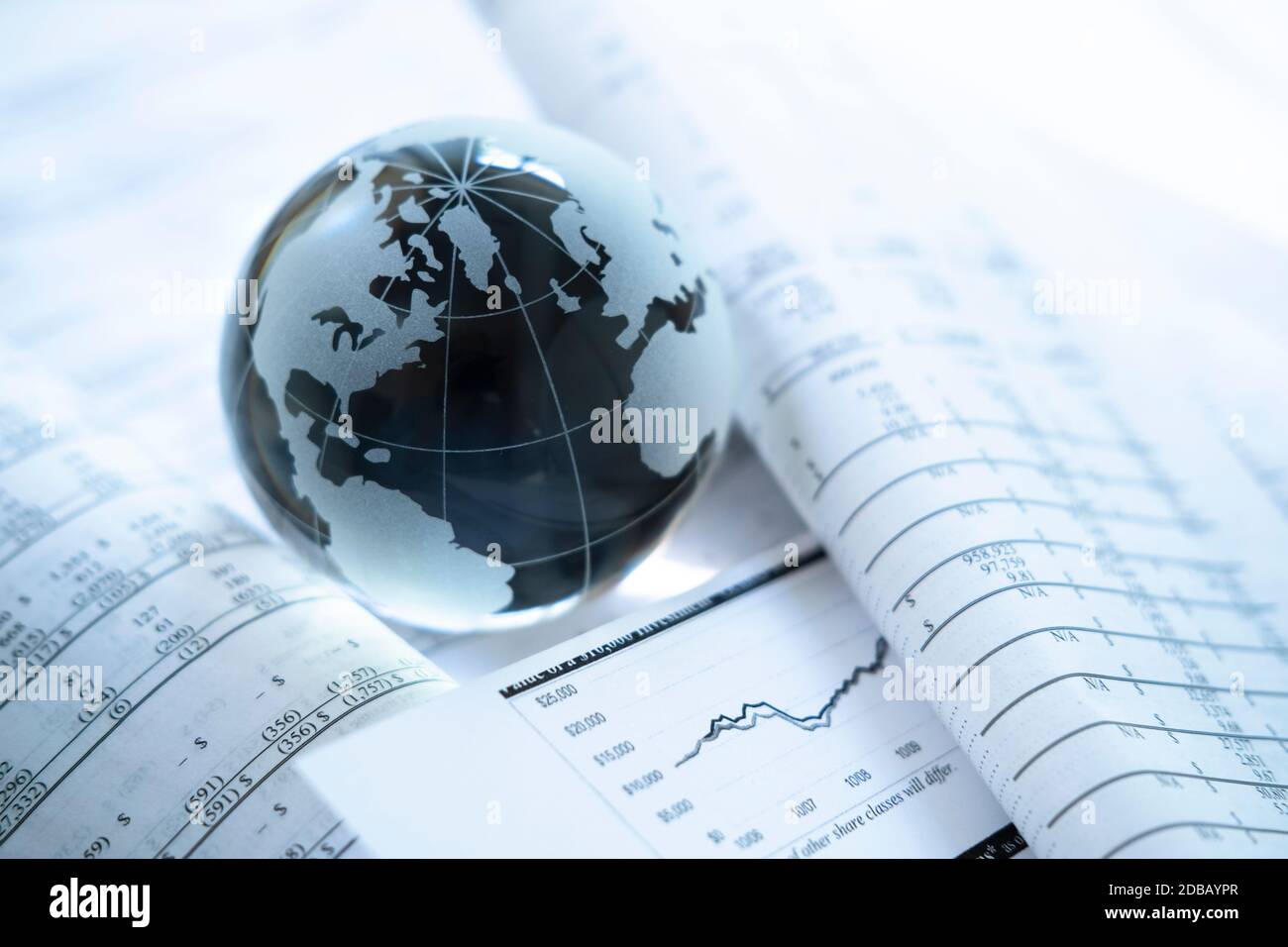 Glass globe an financial documents Stock Photo
