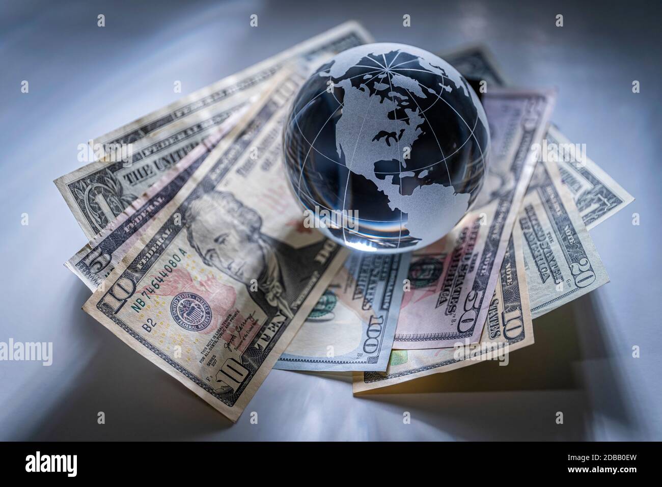 Glass globe and american dollar banknotes Stock Photo