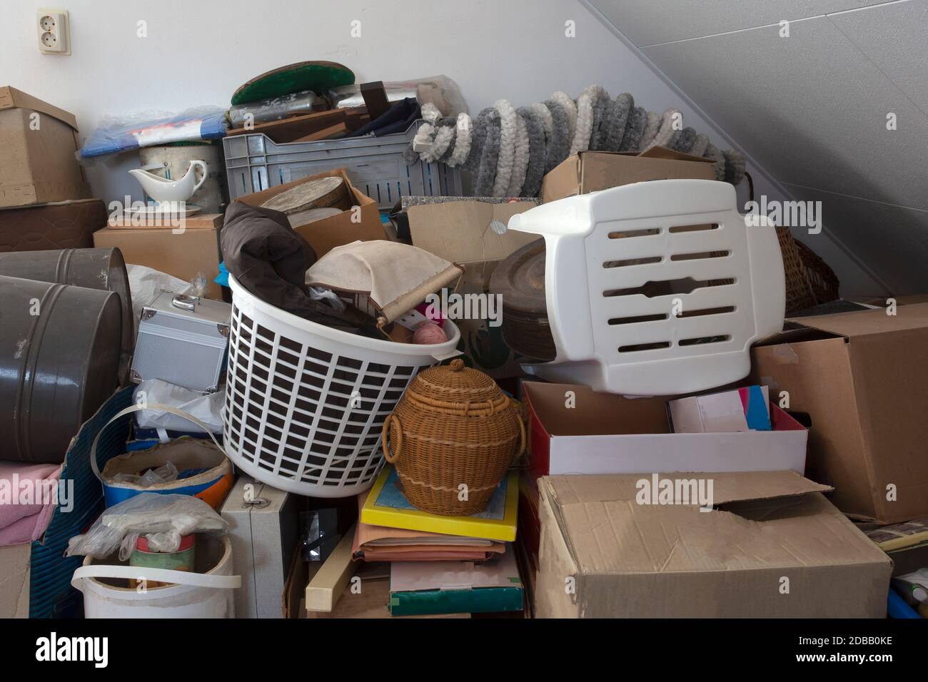 Pile of junk in a house, hoarder room pile of household equipment needs clearing out storage Stock Photo