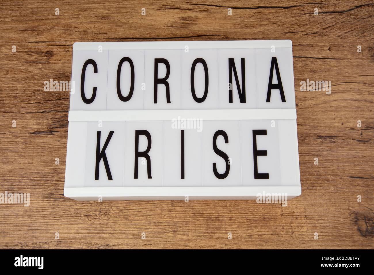 Concept: Corona Krise  in german language over wooden background means Corona Crisis Stock Photo