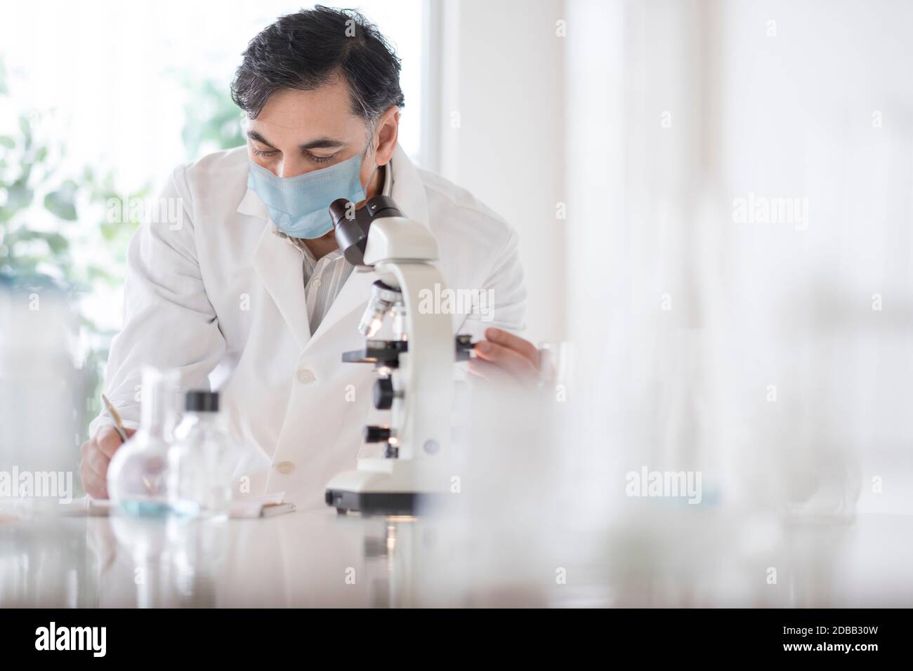 Doctor using microscope Stock Photo Alamy