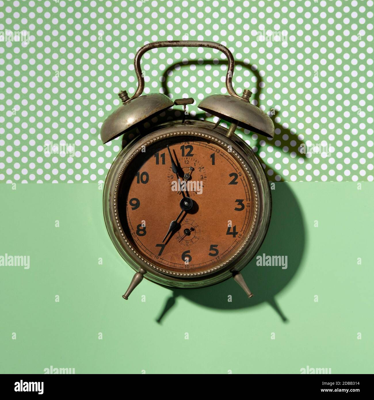 Vintage alarm clock on green background Stock Photo Alamy
