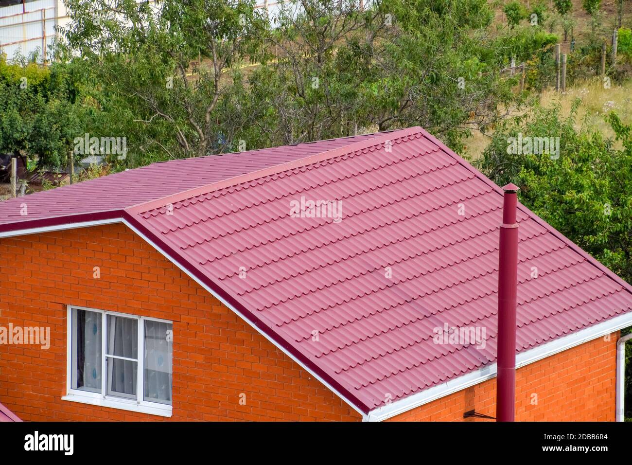 Roof made of metal. Construction with modern roofing materials. Corrugated metal profile Stock