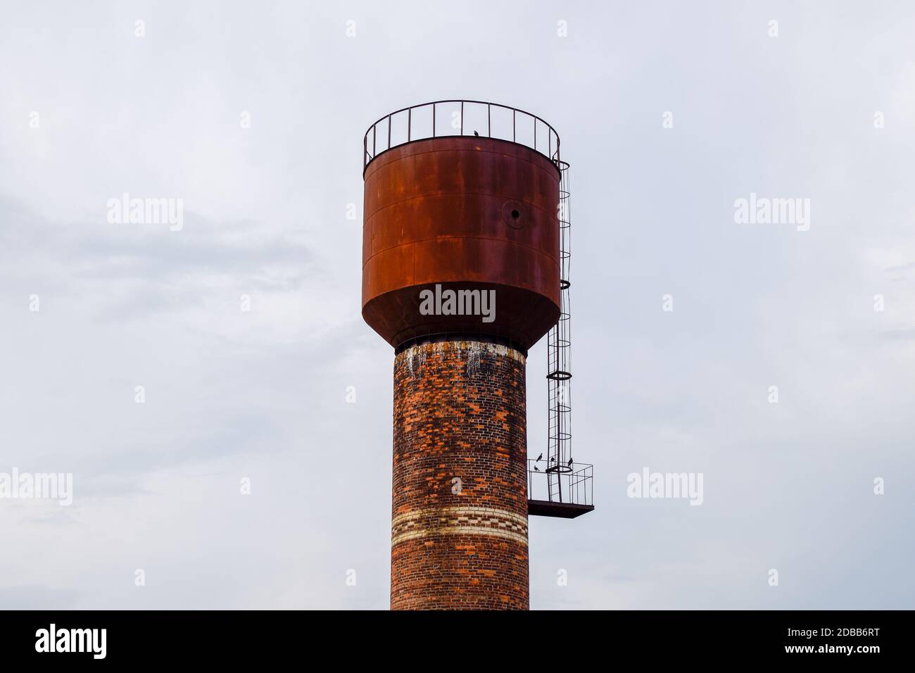 Rusty water tower against the sky. Old water pump Stock Photo - Alamy