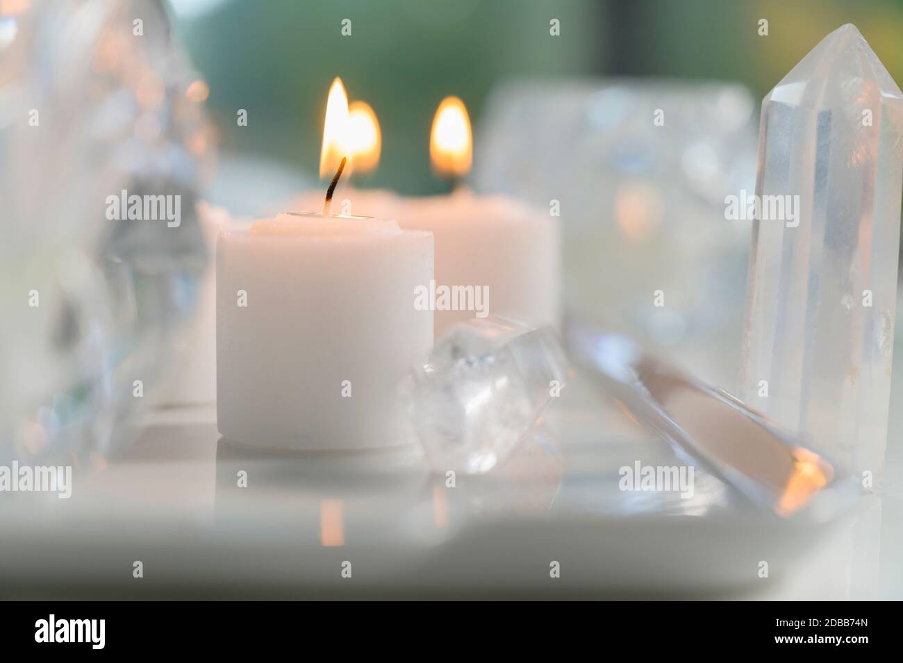 Composition of burning candles and crystals Stock Photo Alamy