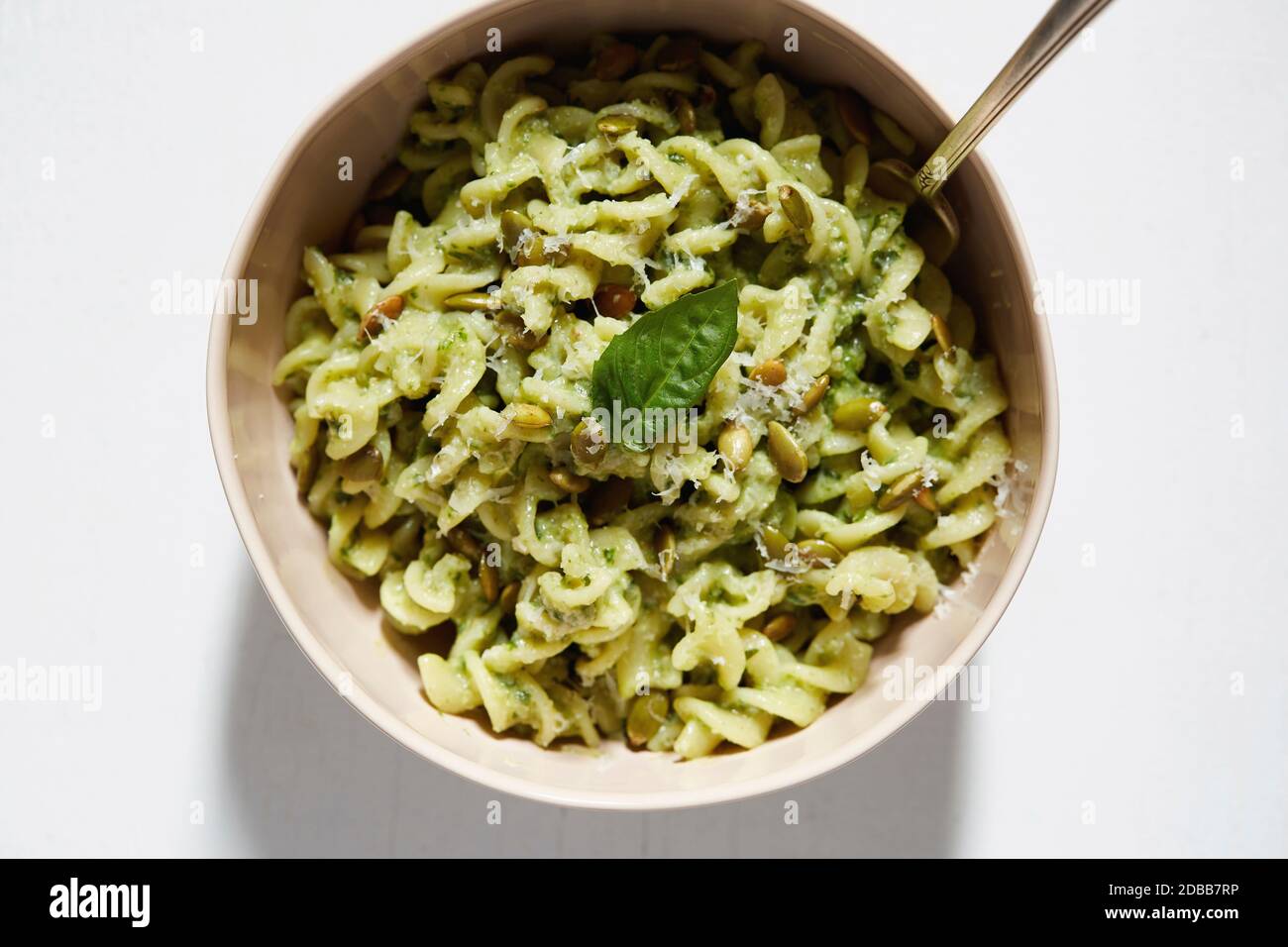 Pasta with avocado and basil in bowl Stock Photo