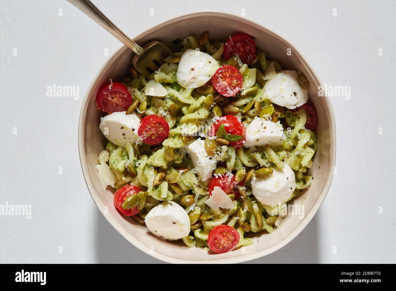 Pasta with Bocconcini and cherry tomatoes in bowl Stock Photo