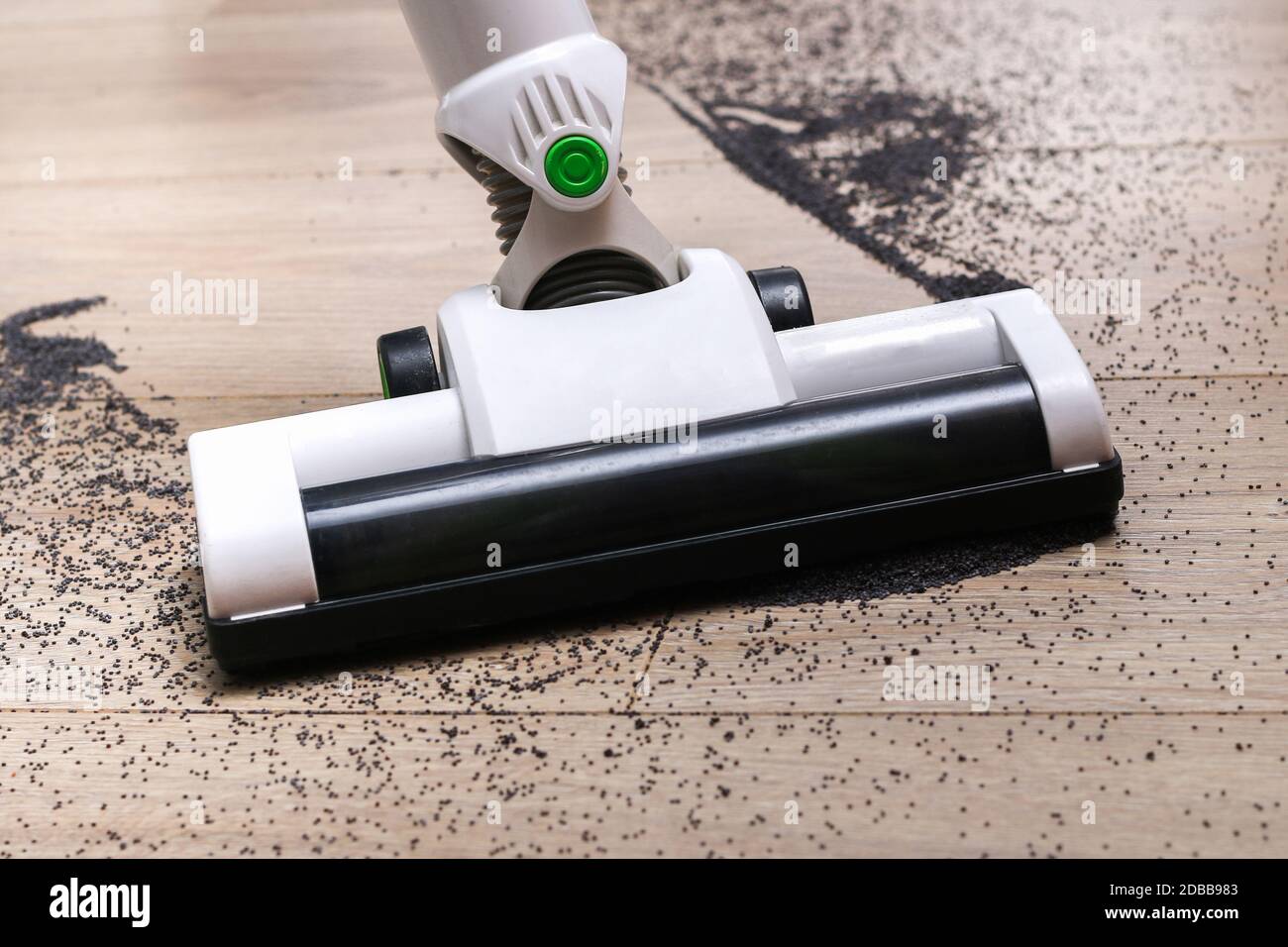 A man uses a bagless vertical cordless vacuum cleaner to clean the floor Stock Photo Alamy