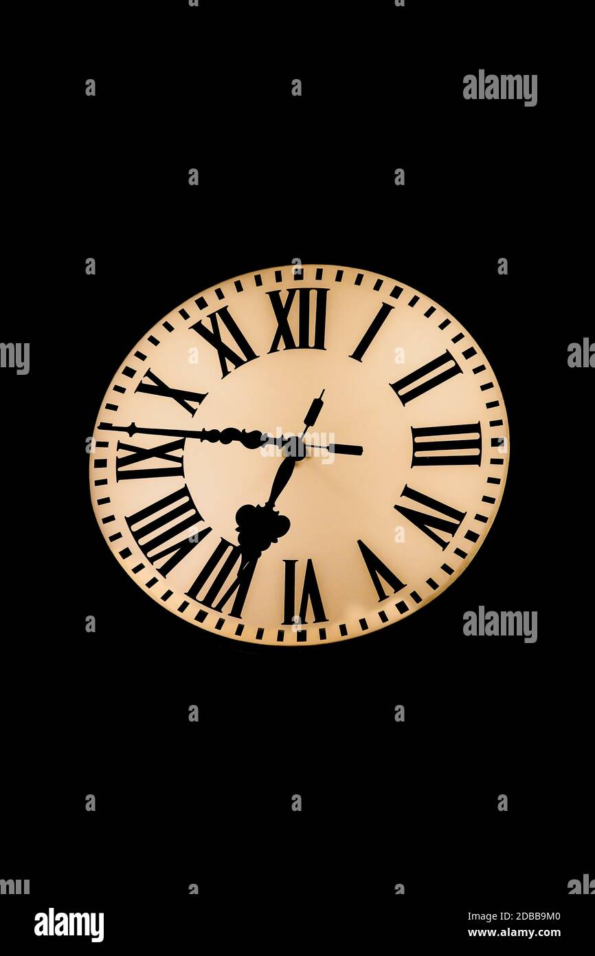 View of an illuminated clock, clock face in the dark Stock Photo Alamy
