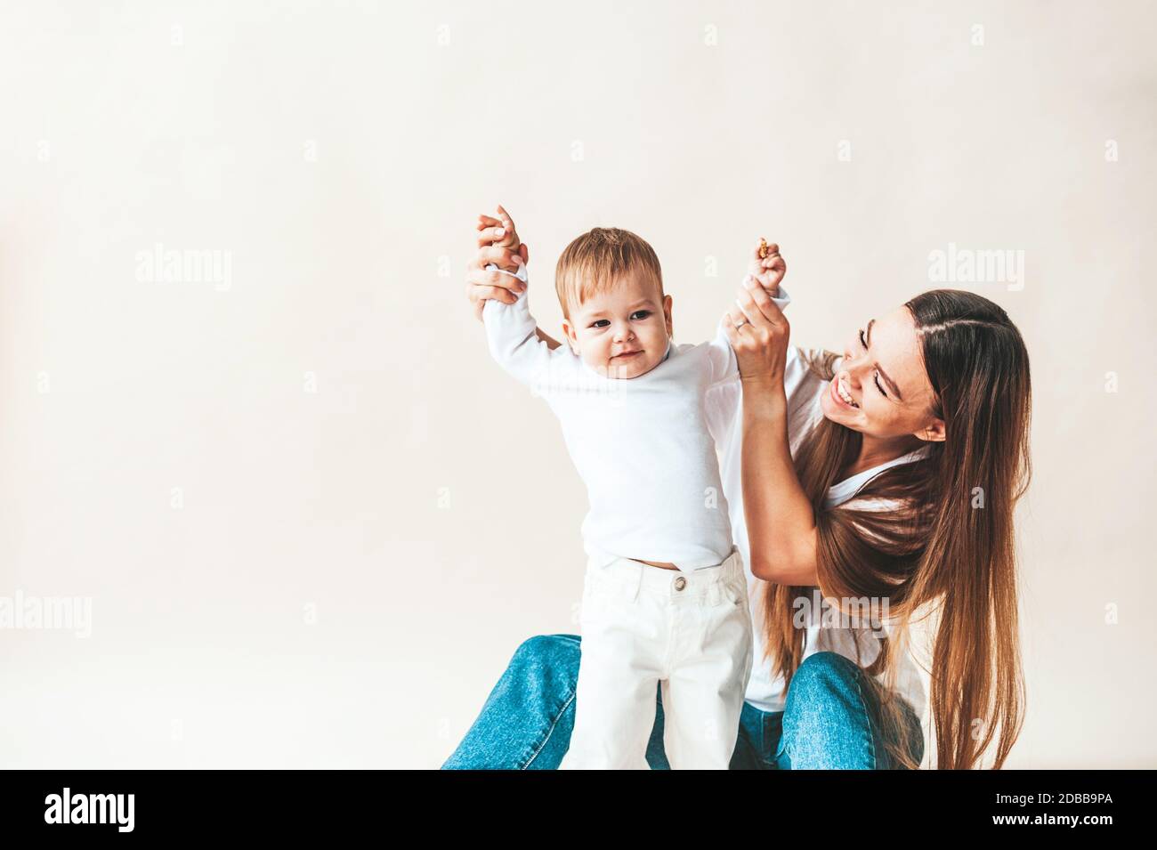 Mom and baby raise their arms up Stock Photo Alamy