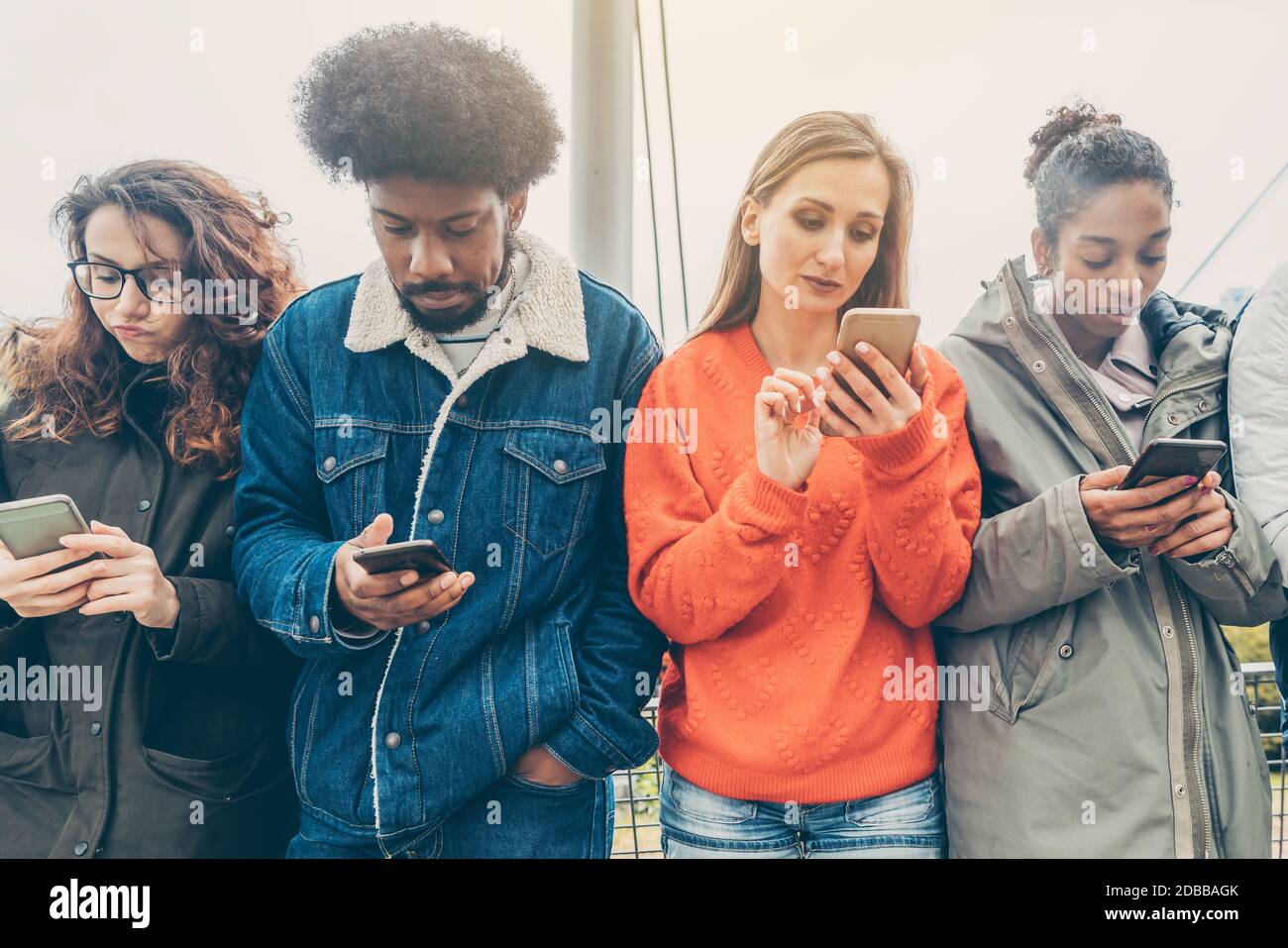 People choosing their phones over personal interaction because 21st century and so Stock Photo