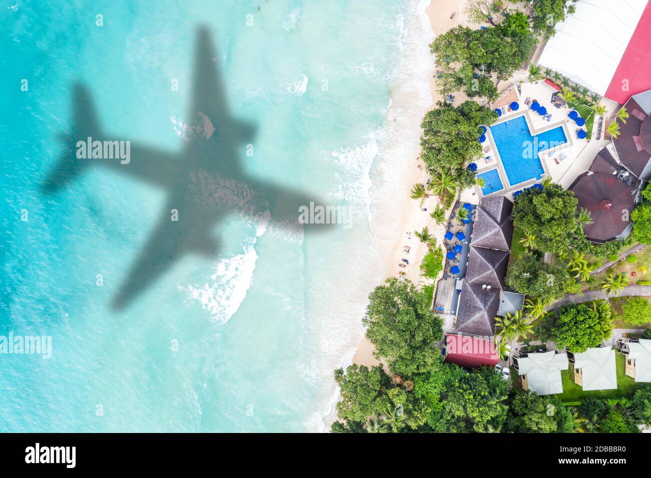 Symbolic picture vacation travel traveling luxury villa sea airplane flying Seychelles aerial photo beach waves Stock Photo