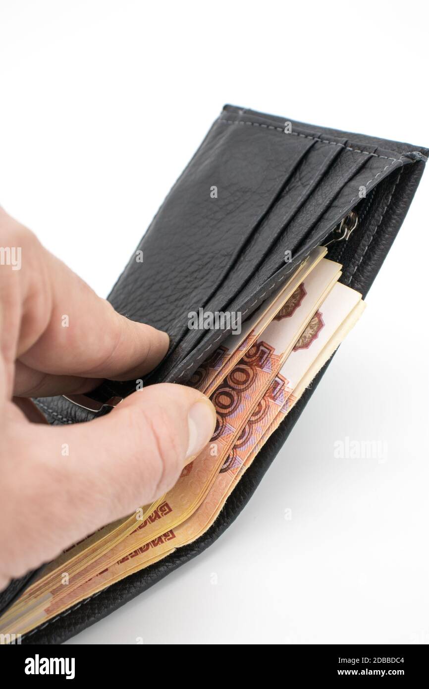 a purse with money on a white background and a hand that counts bills 2DBBDC4