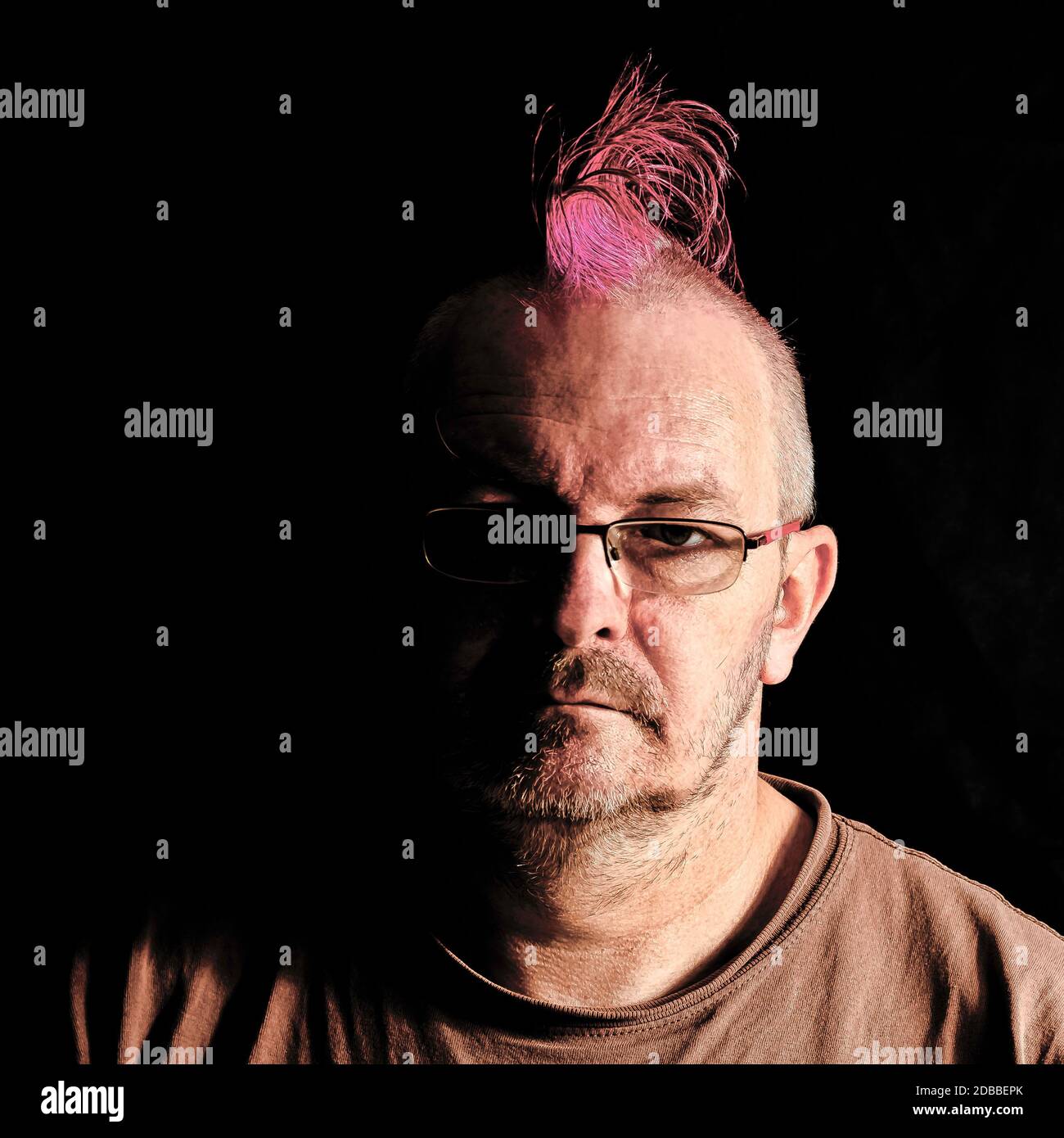 Male with mohawk hair in pink - London, United Kingdom Stock Photo