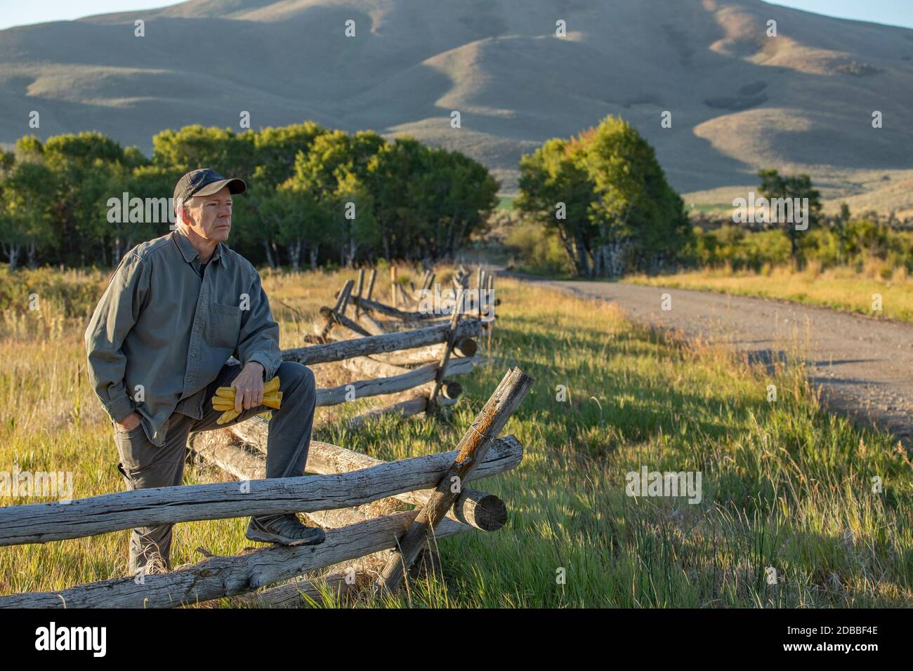 USA, Idaho, Bellevue, Farmer leaning against fence on field Stock Photo