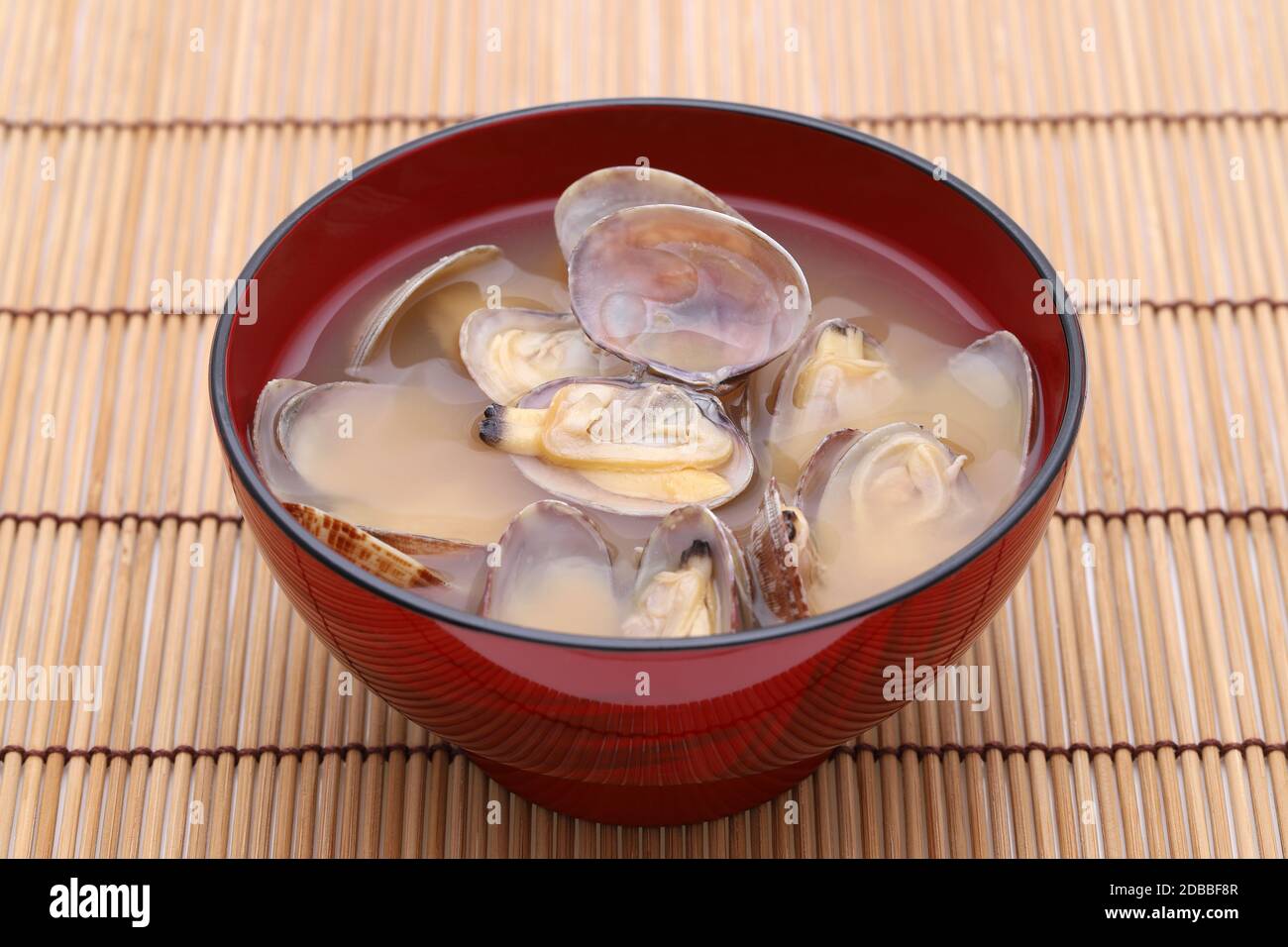 Japanese miso soup with asari clams in a bowl on bamboo table Stock Photo