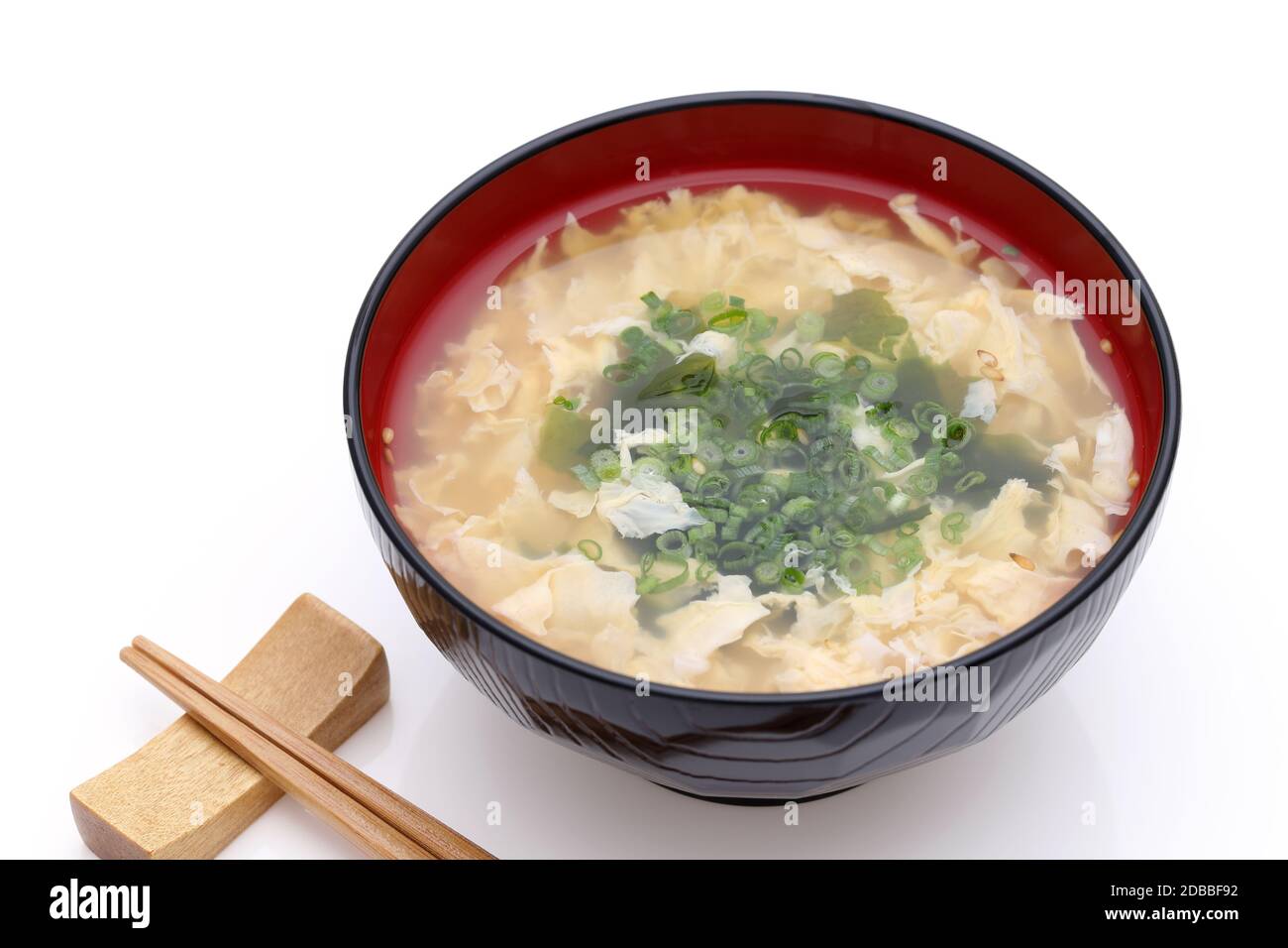 Japanese foof, Tokitama egg soup in a wooden bowl with chopsticks on white backgroundã€€ Stock Photo