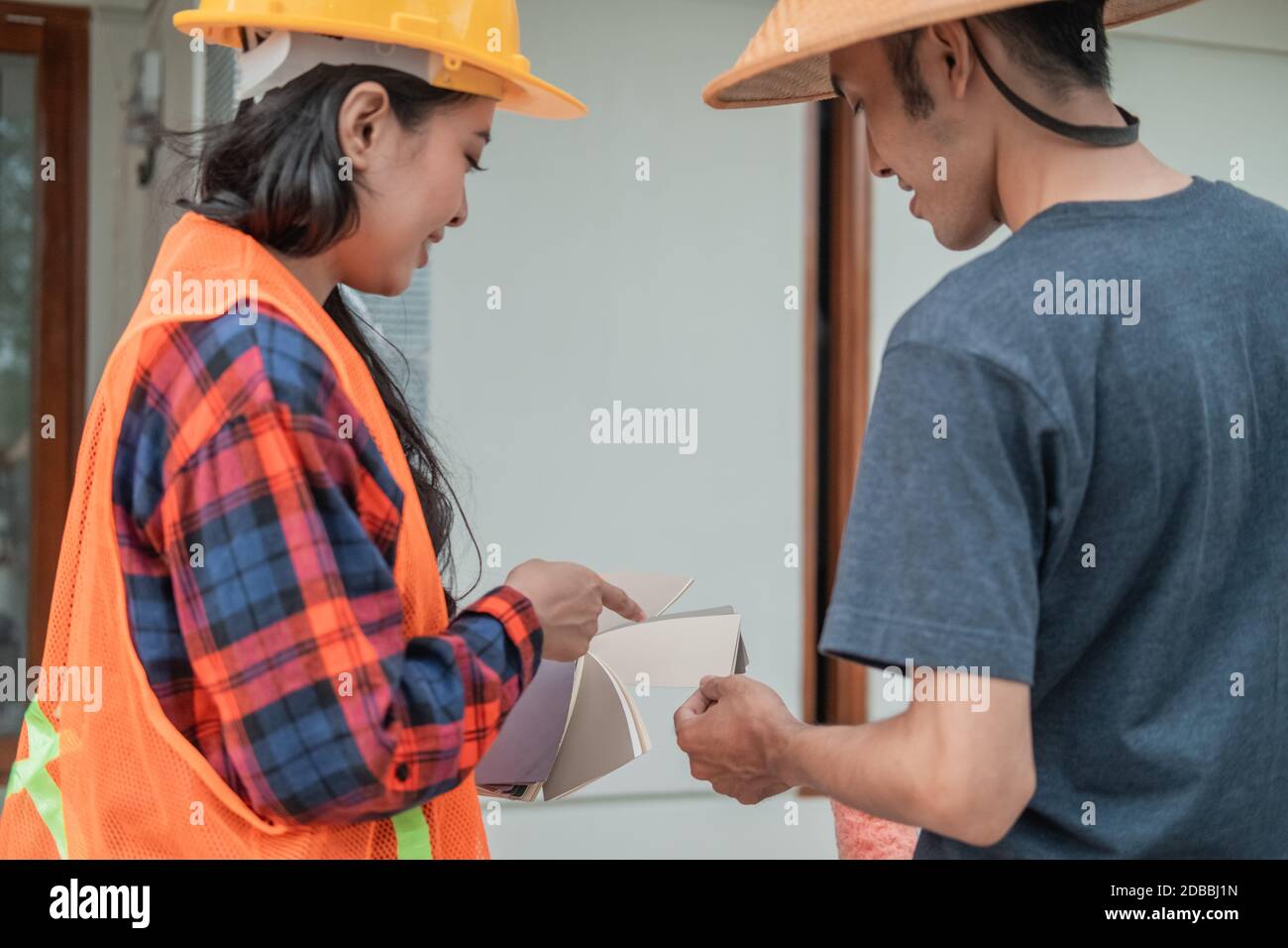 view from behind of a female constructor with pointing finger showing ...