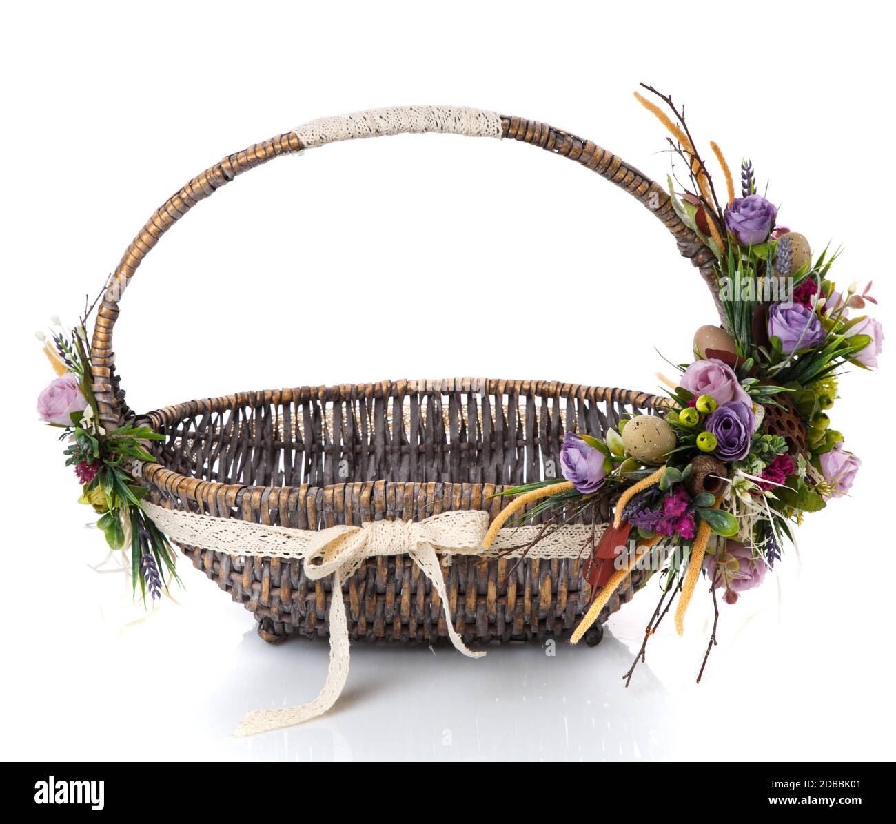 Natural wicker basket with flowers and ribbons. Beautiful bow on the ...