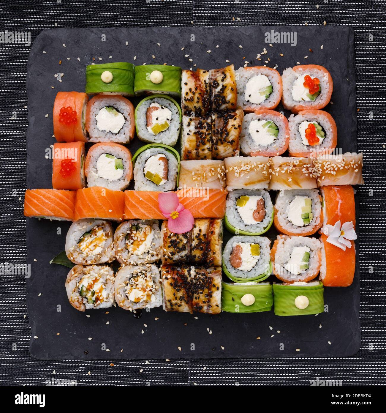 Japanese sushi set. Various types of roles on plate over stone