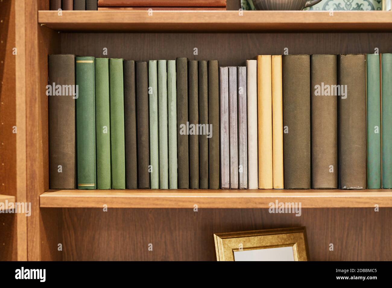 Bookshelf with series of books in rows Stock Photo