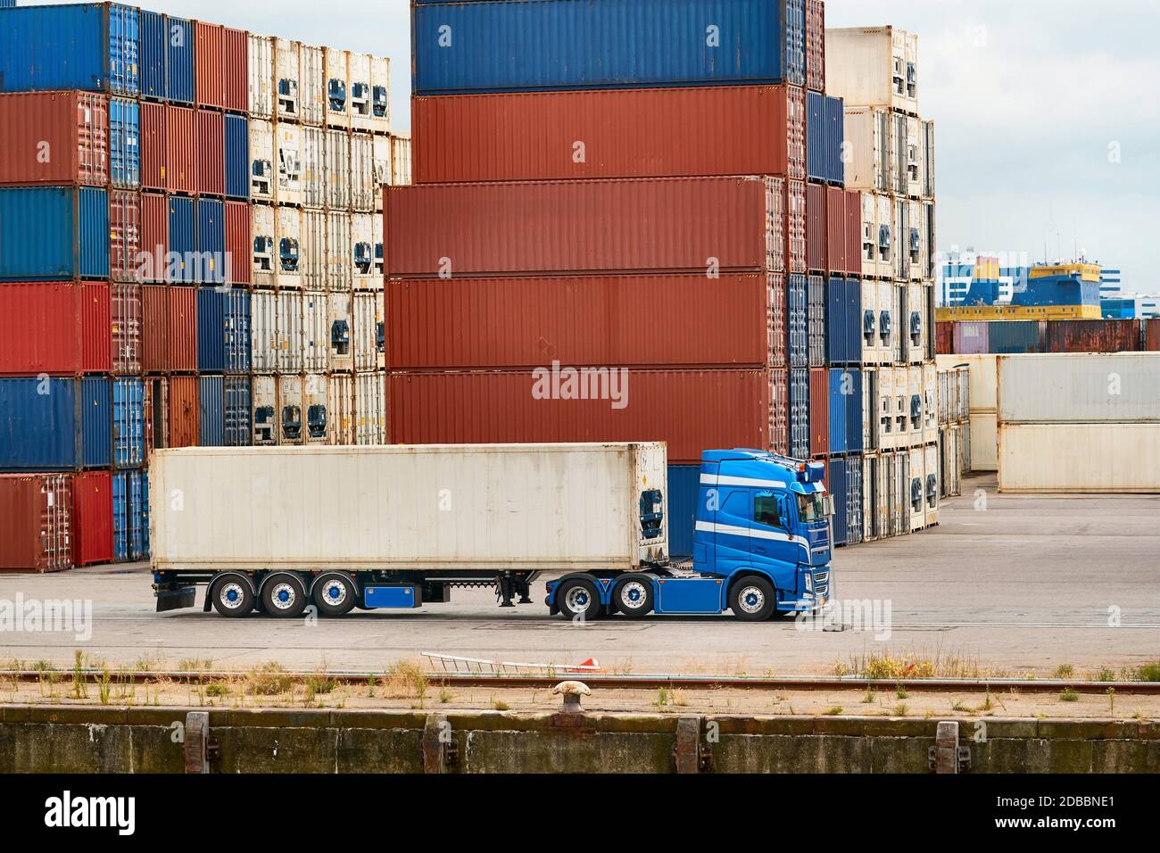 Cargo containers stack, semi truck in an intermodal shipping hub ...