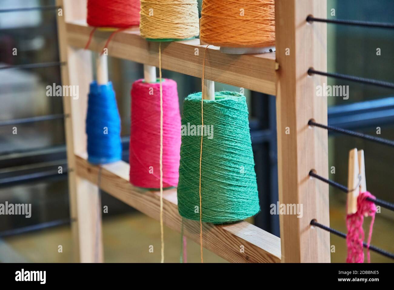 Colored threads for knitting on a rack Stock Photo - Alamy