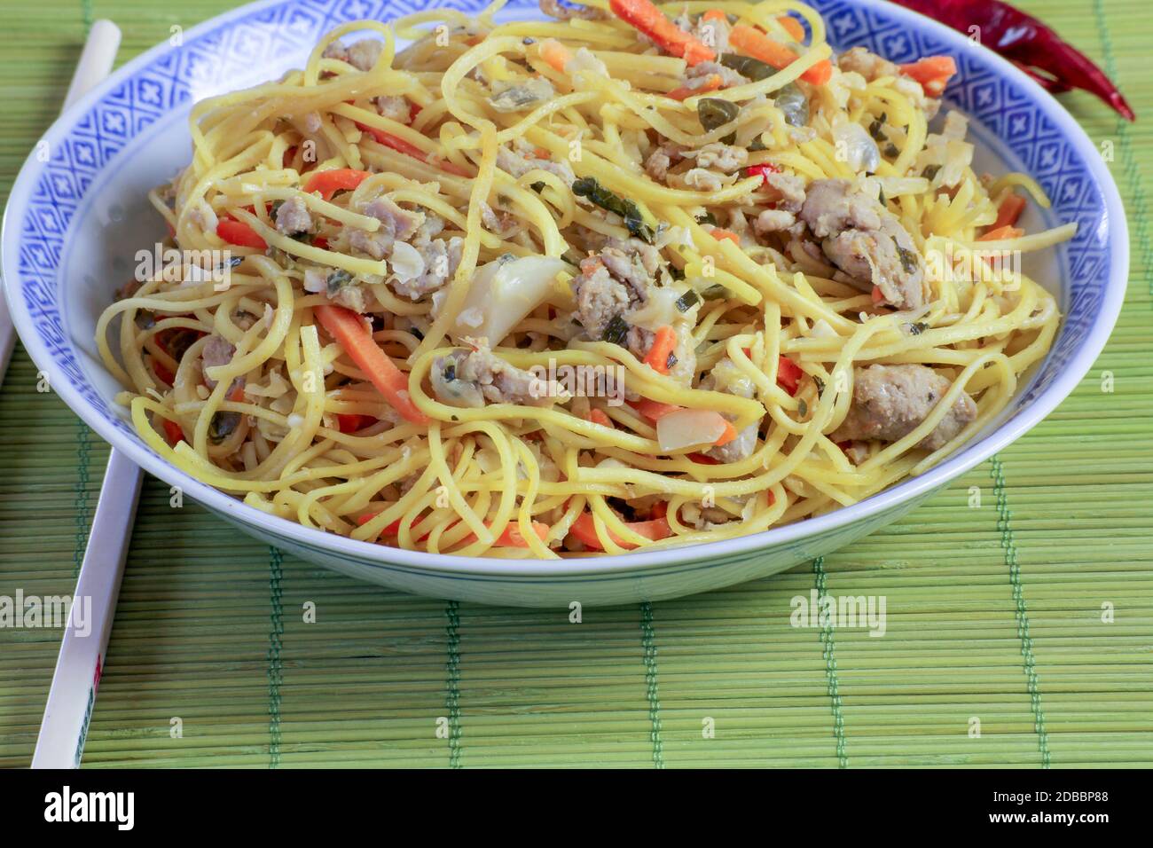 Chinese noodles stirfried with pork Stock Photo Alamy
