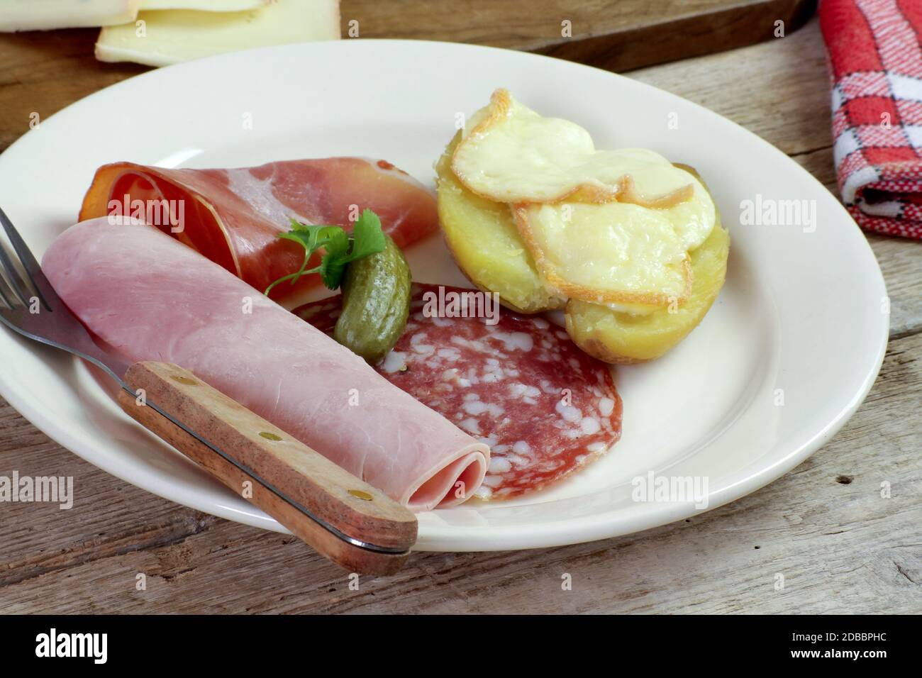 plate of raclette cheese, potatoes and cold cuts Stock Photo - Alamy
