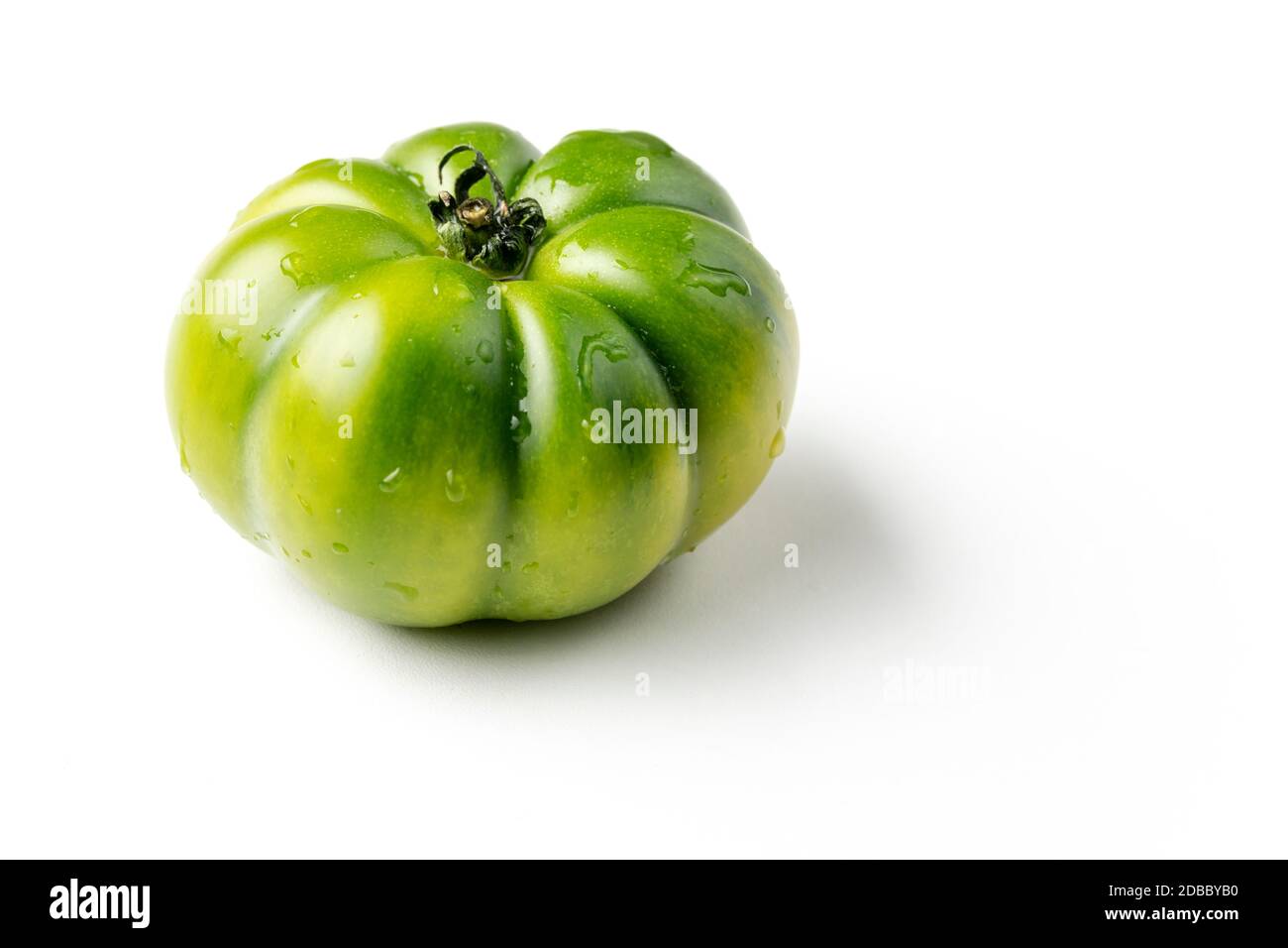 fresh green tomato on white background Stock Photo - Alamy