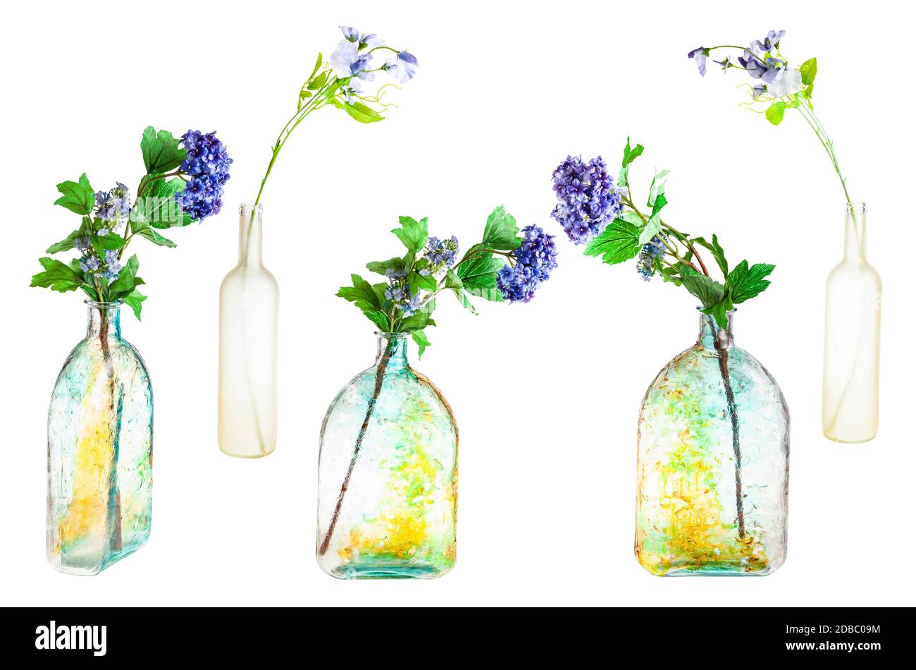 set of artificial flowers in hand painted glass bottles isolated on white background Stock Photo