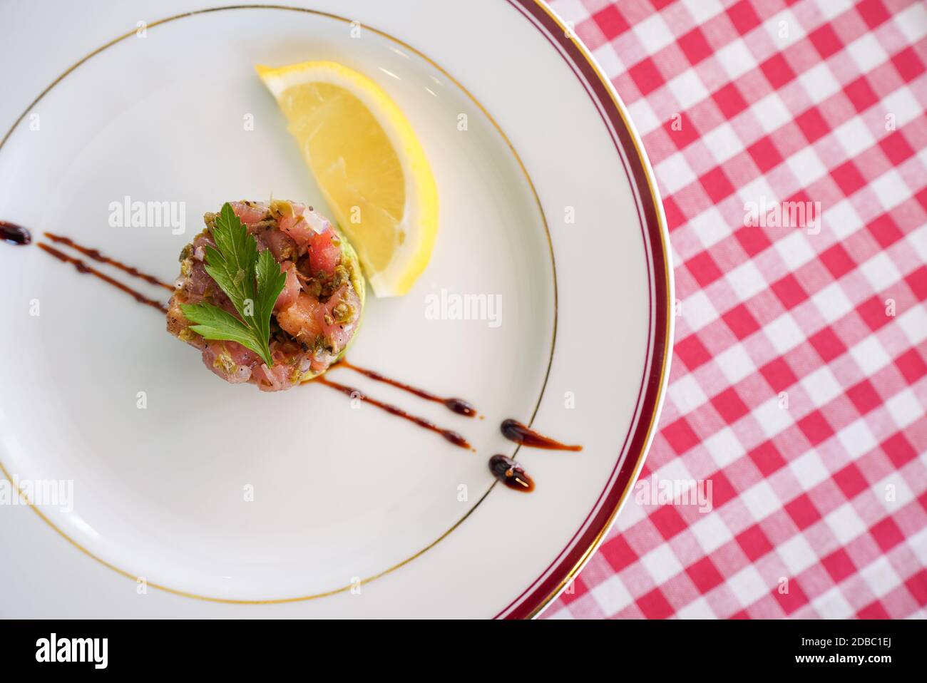 TARTARE DI TONNO O SALMONE. Finely diced tuna and salmon mixed with