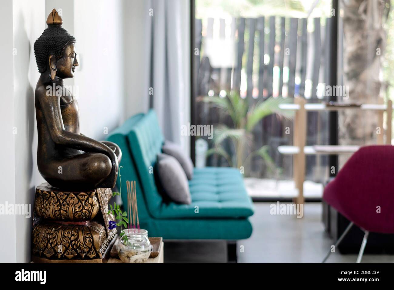 bronze buddha statue interior design detail in modern asian home living room Stock Photo