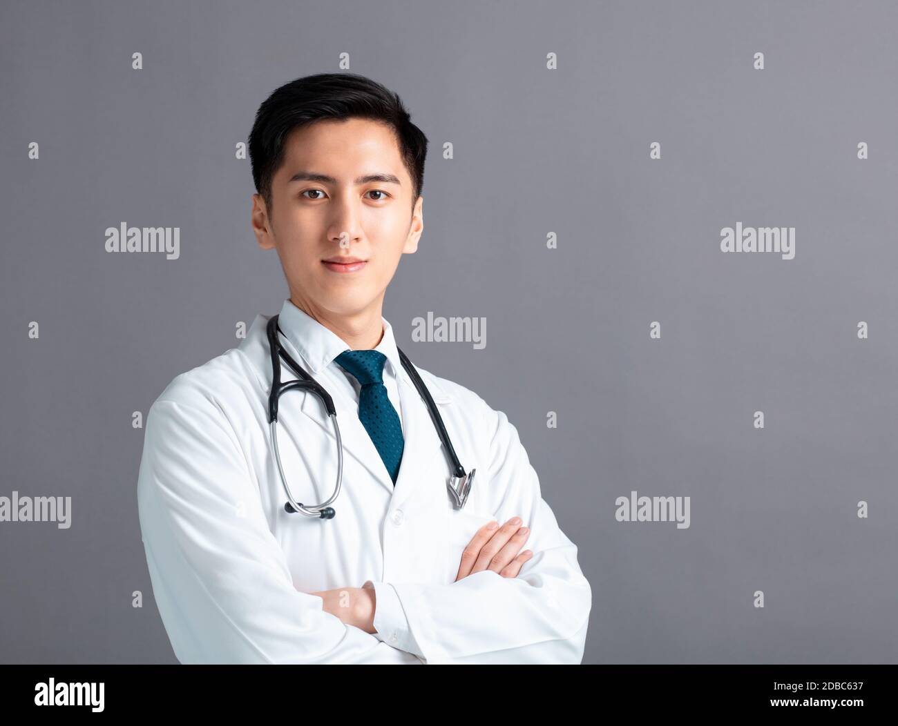 Young smiling doctor on gray hi-res stock photography and images - Alamy