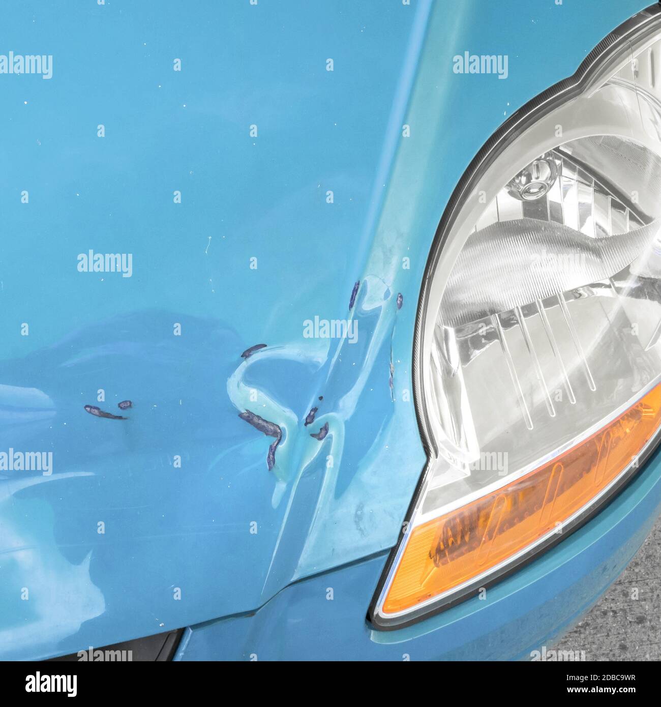 Damaged bodywork. Dents and scratch marks on a car's hood. Closeup