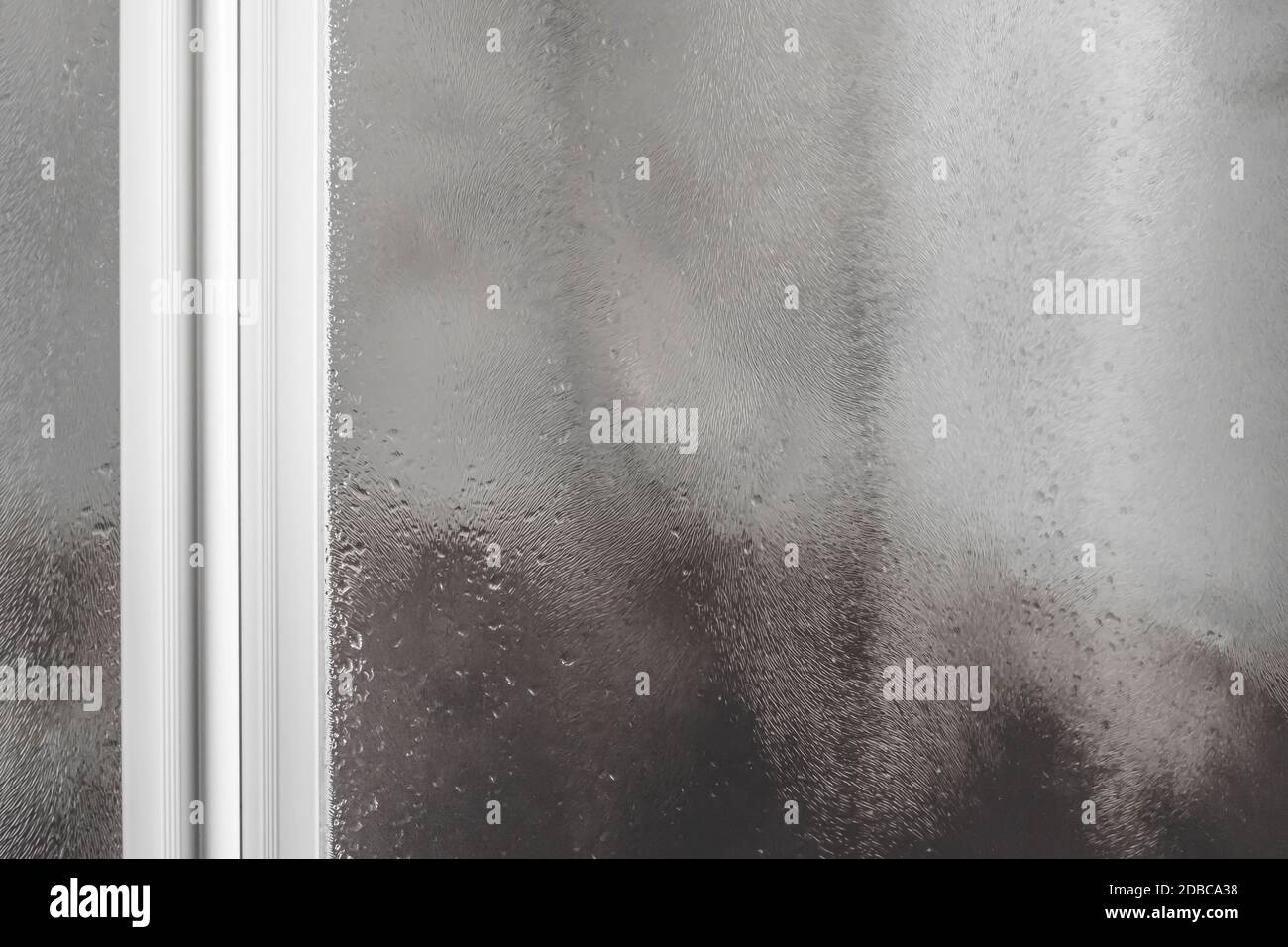 Wet shower stall. Drops of water on the glass. Drops of water flow down the misted glass. Stock Photo