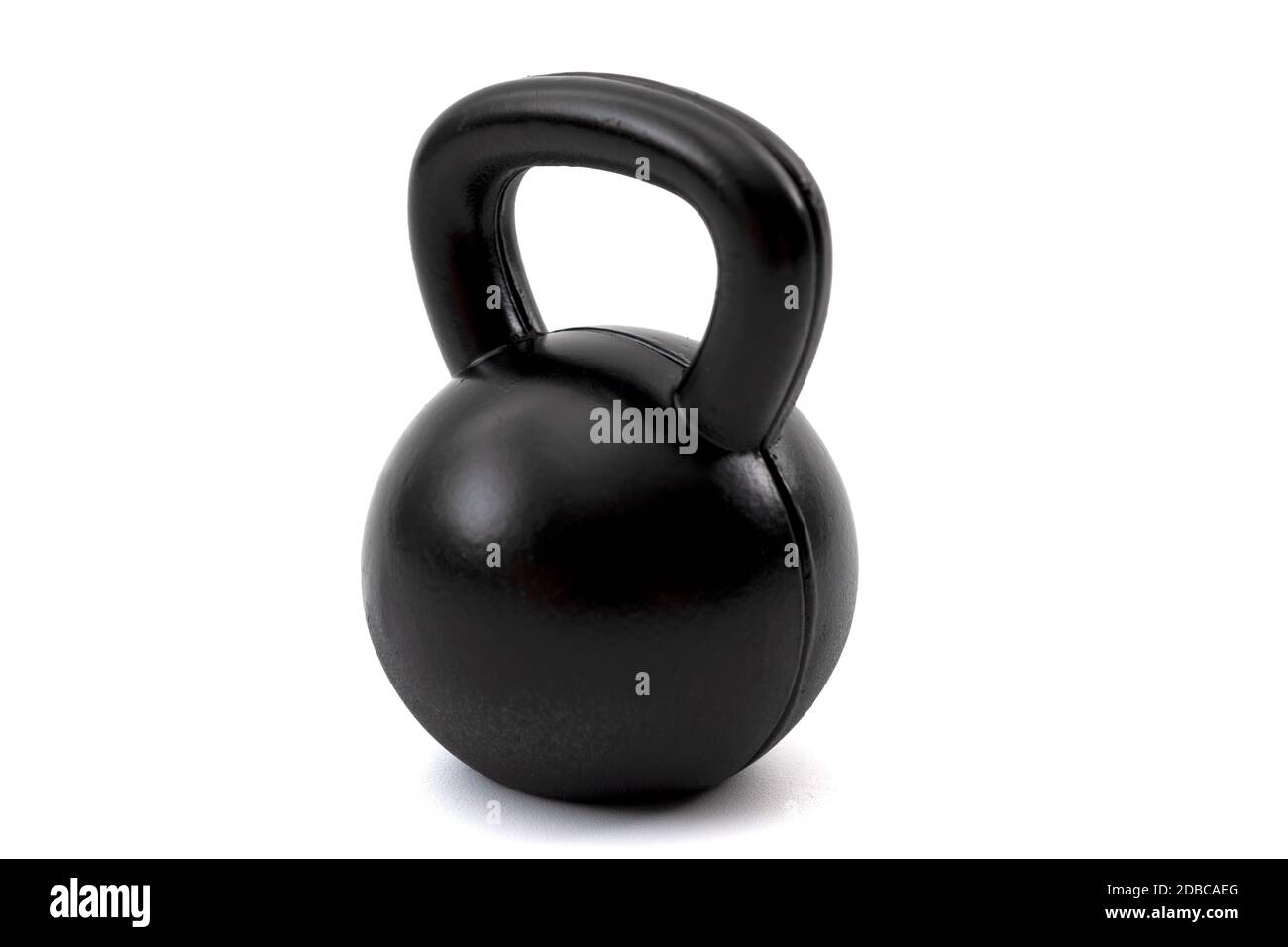 Train with heavy weights, weightlifting exercising and build muscle through resistance training concept with a single black kettlebell isolated on whi Stock Photo