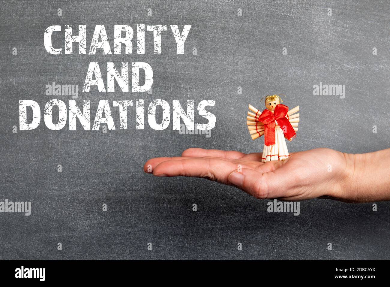 Charity and Donations. Woman holding a straw angel. Christmas ...