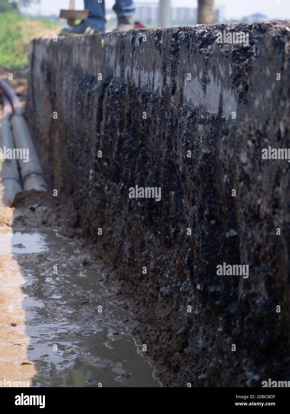 installing concrete drains on the side of the road Stock Photo Alamy