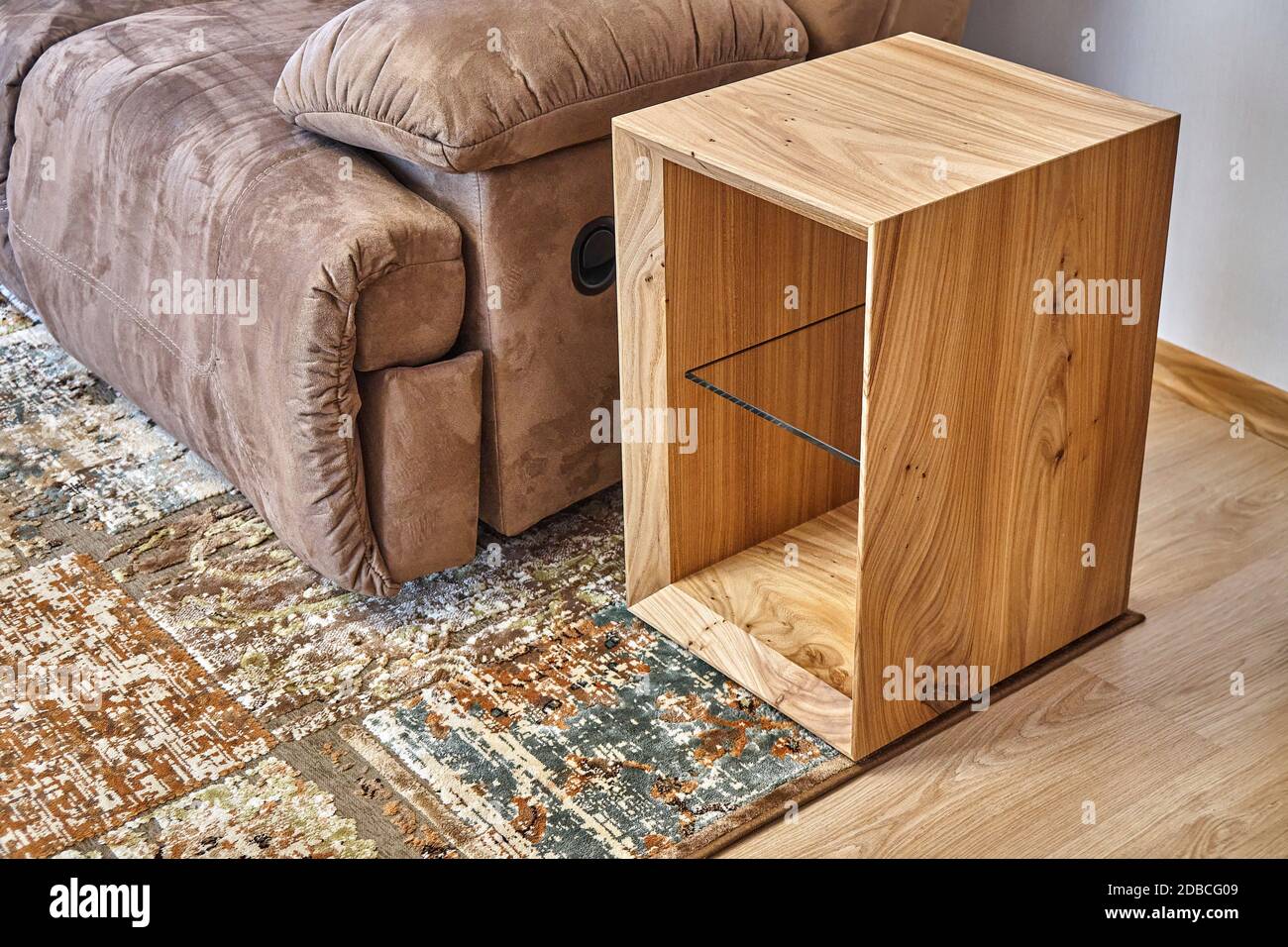 Live edge elm slab sofa side table in contemporary living room. Modern furniture close-up Stock Photo