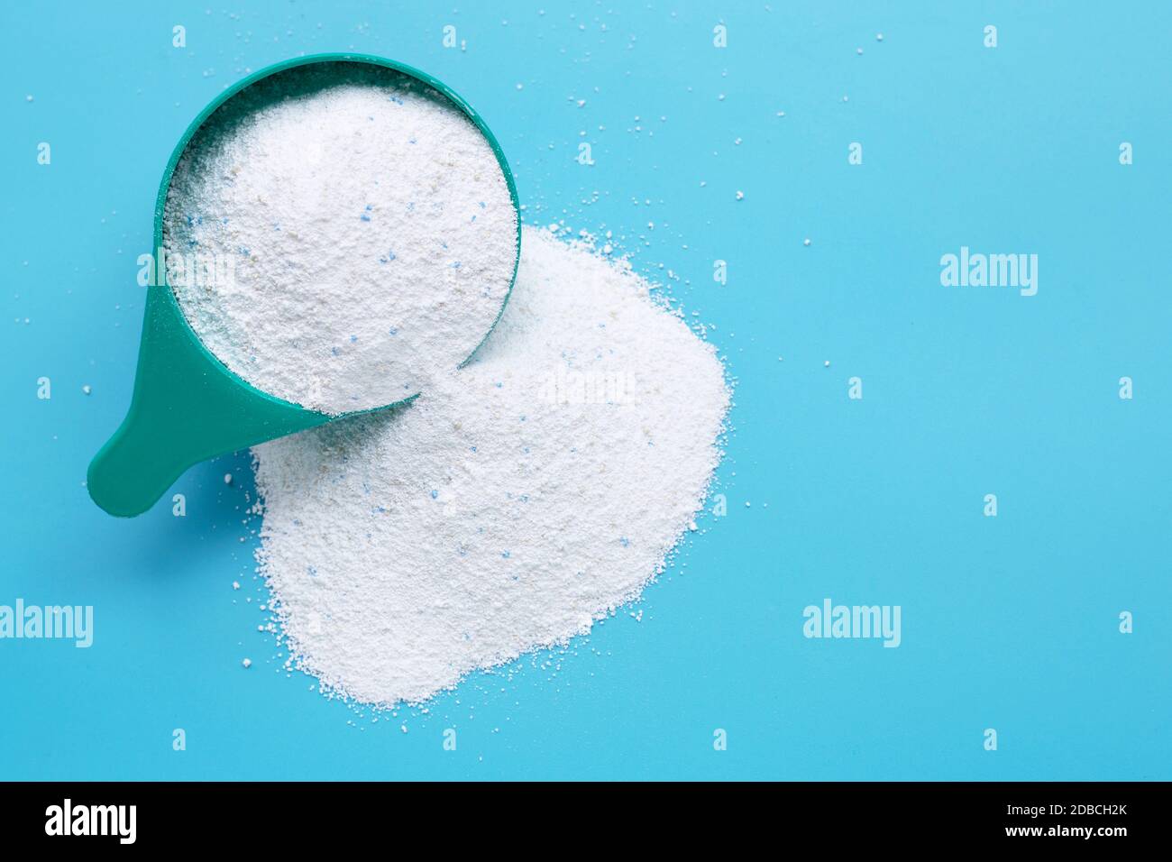 Washing laundry detergent powder and blue plastic measuring cup, top view  Stock Photo - Alamy