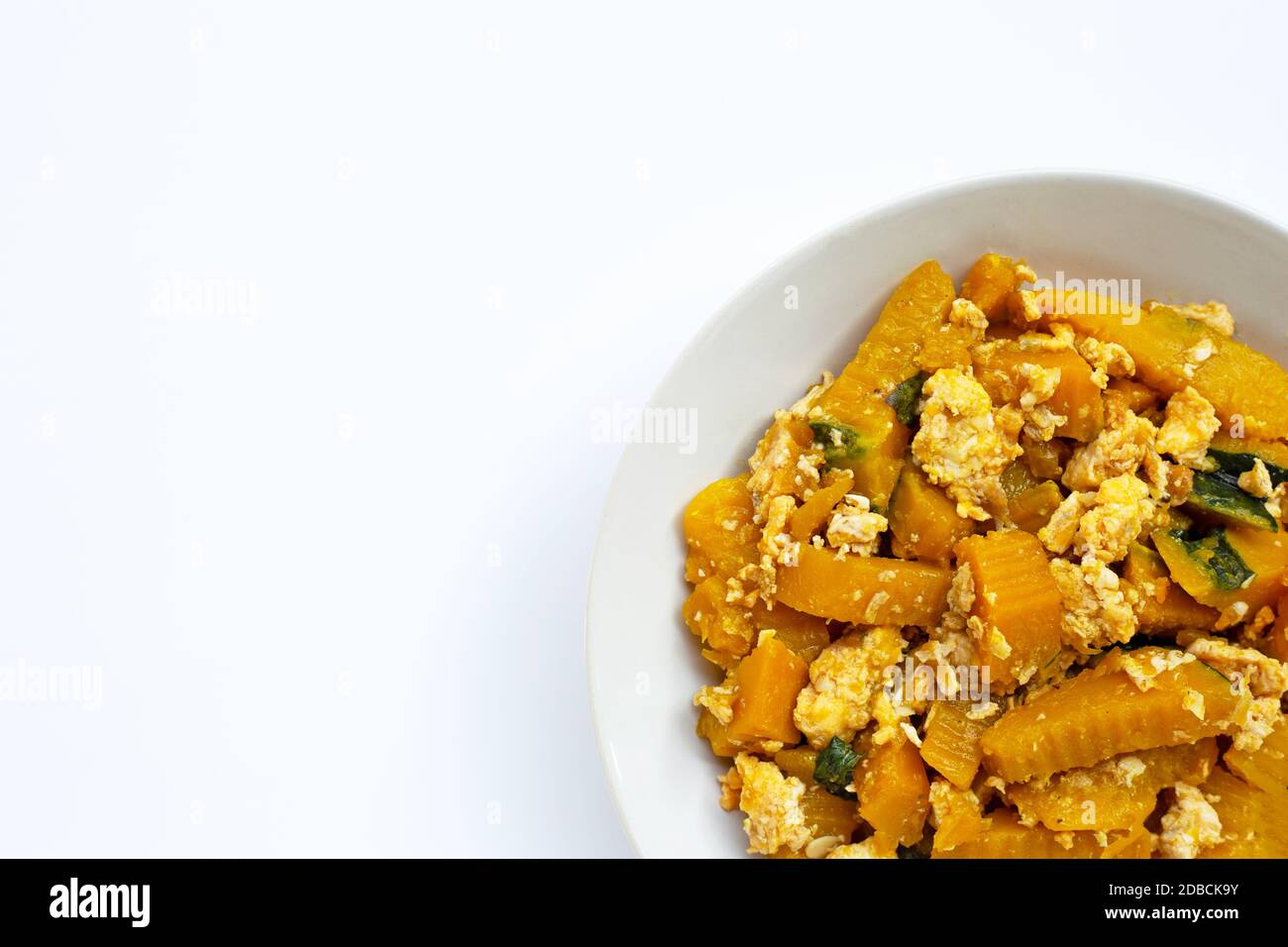 Stir-fried pumpkin with eggs on white background. Stock Photo