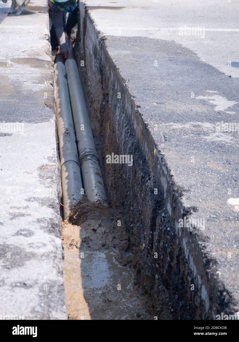 installing concrete drains on the side of the road Stock Photo Alamy