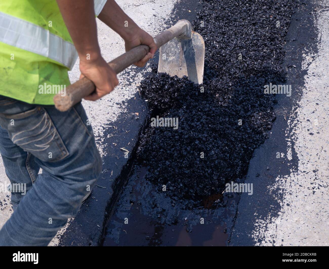 Worker use vibratory plate compactor compacting asphalt at road repair Stock Photo Alamy