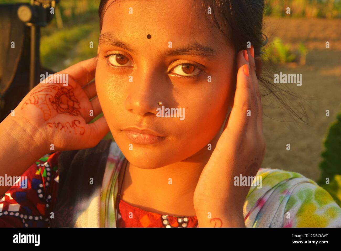 Close up of a teenage girl with nose pin and black bindi in her forehead, selective focusing Stock Photo