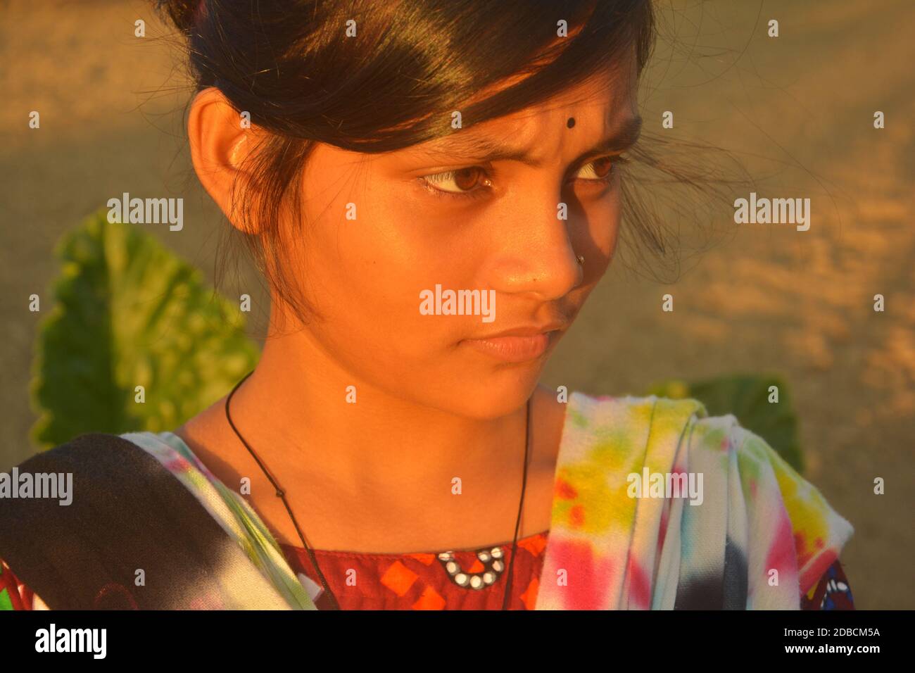 Close up of a teenage girl with nose pin and black bindi in her forehead, selective focusing Stock Photo